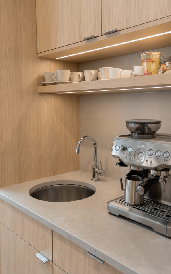 A dedicated beverage area keeps the morning coffee rush or evening wine-down from crowding the main kitchen. It creates flow, adds function, and creates a unique design feature.
