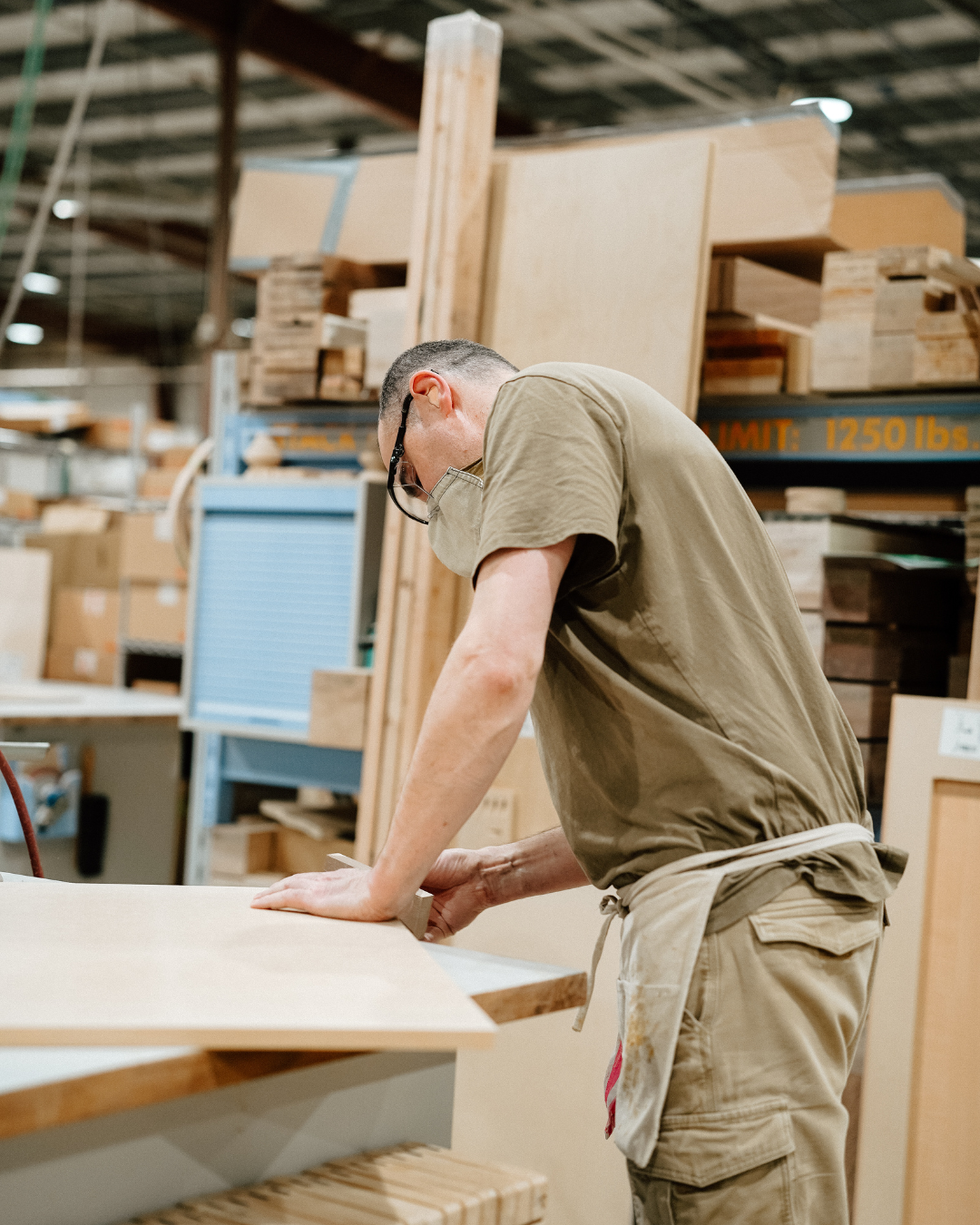 A man working on production, making a kitchen hood